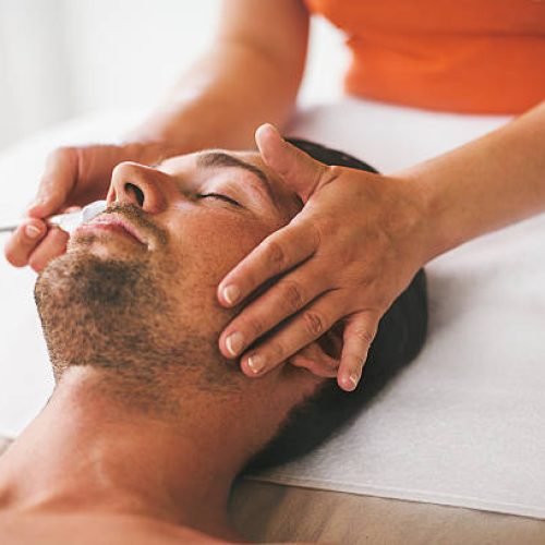 Man getting a face treament at the health spa Man getting a face treament at the health spa